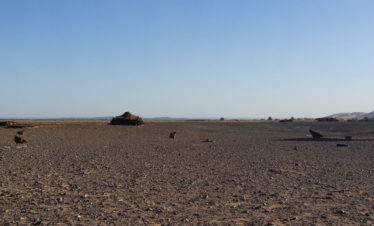 view of nomad family tent with big dunes in distance