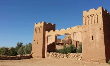 front gate of Kasbah Ait Ben Haddou against clear blue sky