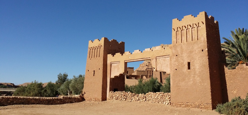 front gate of Kasbah Ait Ben Haddou against clear blue sky