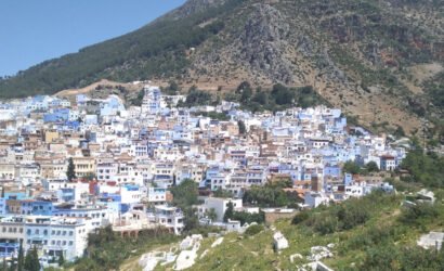 Chefchaouen nestled in the foothills of the Rif Mountains - feature image for 8 day Morocco itinerary from Tangier to Marrakesh - Mountains, Medinas & Nomad Tents