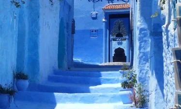 view looking up blue steps towards blue door in Chefchaouen