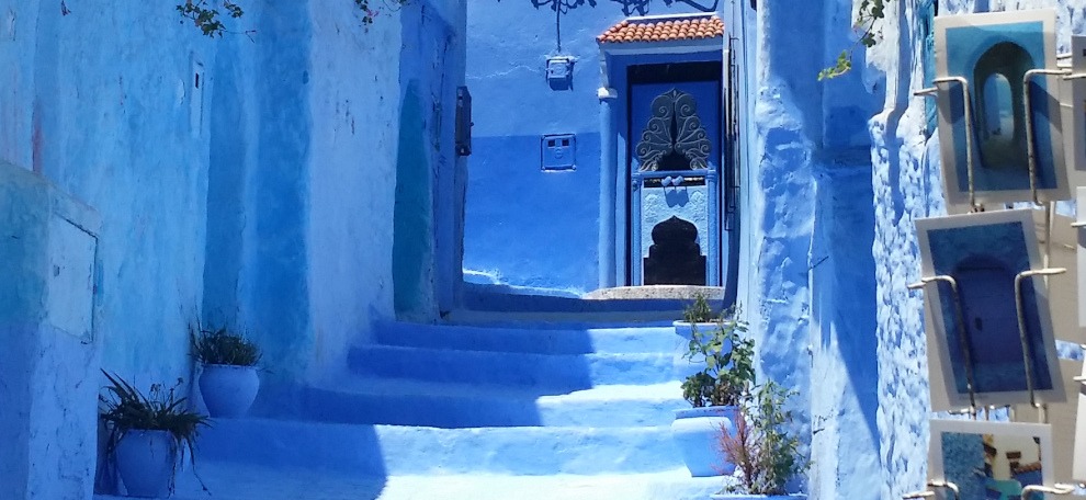 view looking up blue steps towards blue door in Chefchaouen