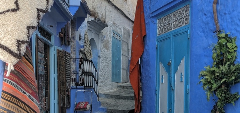 Blue-painted buildings lining a curving street in Chefchaouen (Blue City) - gallery image for 8 day Morocco itinerary from Tangier to Marrakesh -Mountains, Medinas & Nomad Tents