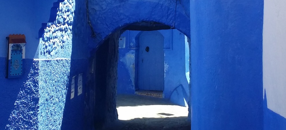 blue door as seen through blue arched passage - Chefchaouen