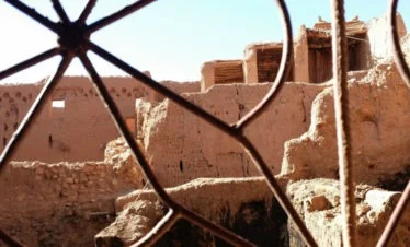 view of Ait Ben Haddou buildings and rooftops through wrought-iron window