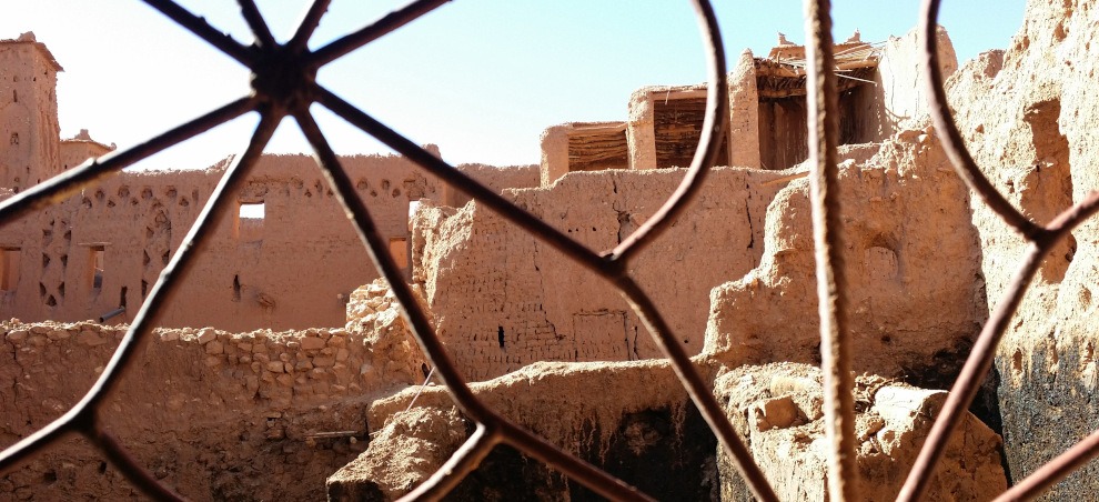 view of Ait Ben Haddou buildings and rooftops through wrought-iron window