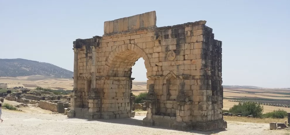 Roman ruins of large arched gate at Volubilis -gallery image for 8 day Morocco itinerary from Tangier to Marrakesh - Mountains, Medinas & Nomad Tents