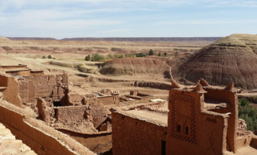 view of buildings, valley and distant mountains from rooftops of Ait Ben Haddou