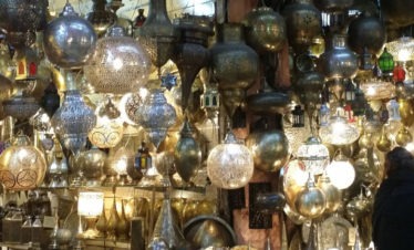 array of cut-metal lamps and lanterns in Marrakesh souk - gallery image for 7 day Morocco itinerary - "Walled Cities & Wide-Open Spaces"