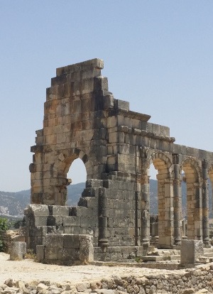 Roman ruins of a stone building with archways at Volubilis