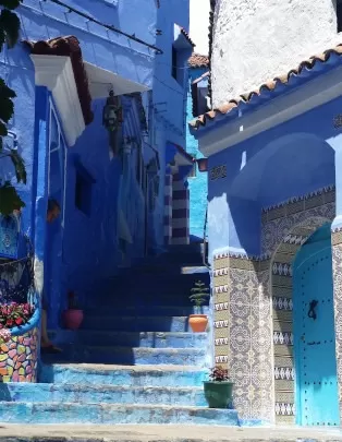 Chefchaouen - the "blue city" - view of winding blue street with blue stairs & blue door