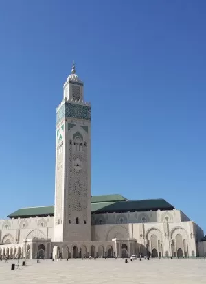 Casablanca- view of Hassan II mosque & minaret from across the square, against bright blue sky